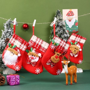 Detail view of four Christmas stockings with Santa, Snowman, Reindeer and Bear 3D dolls