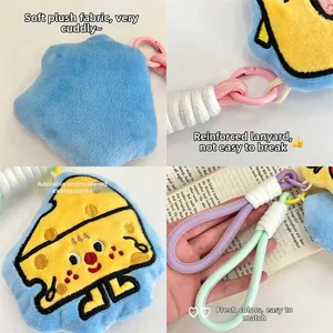 Detailed close-up of cartoon cheese plush pendant showing embroidery and rope keychain