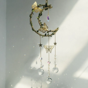 Macro detail of moon-shaped crystal dreamcatcher with golden butterflies and prisms