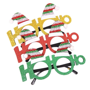 Three festive glitter HO HO HO Christmas glasses with striped Santa hats on white background