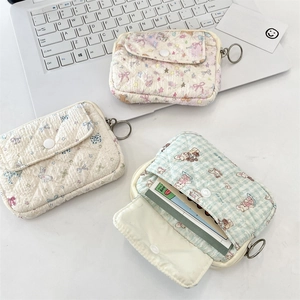Quilted fabric coin purses with floral and rabbit patterns featuring snap closures