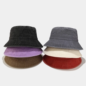 Multiple colors of washed cotton bucket hats including black, grey, and caramel beige
