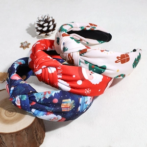 Three Christmas knot headbands in white, red, and navy blue with festive prints