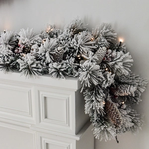 Deluxe snow-flocked Christmas garland with pine cones, berries and warm LED lights
