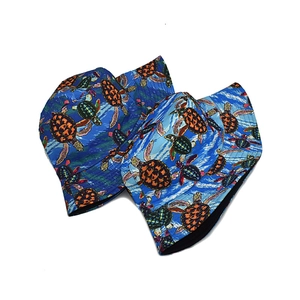 Detailed view of turtle print pattern and neat stitching on blue reversible bucket hats