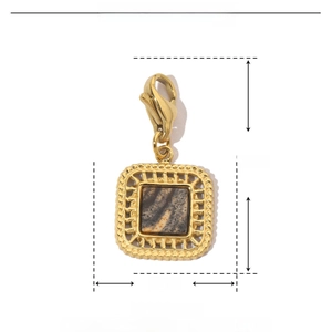 Macro view of gold stainless steel geometric pendant with brown natural stone and clasp