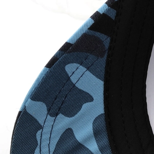 Detailed macro view of the blue camouflage fabric and sturdy stitching on the flat top cap