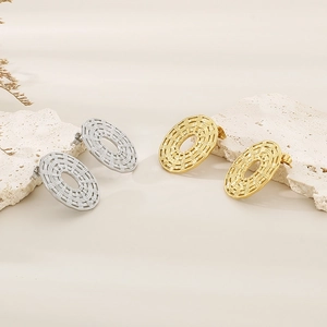 Detailed view of 18K gold and silver plated woven texture oval stud earrings on stone