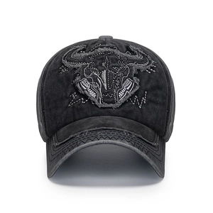 Vintage washed black baseball cap with embroidered bull skull and distressed wavy stitching