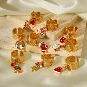 Adjustable gold Christmas rings set with enamel Santa, tree, and bell charms on stone