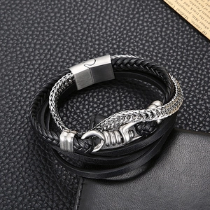 Macro detail of multi-layer men's bracelet with black leather and silver metal chains