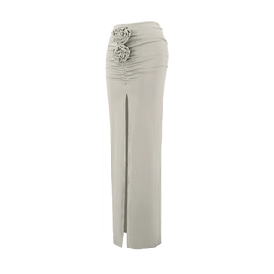 Detailed view of 3D rose ornaments and shirred design on a high-waist slit skirt