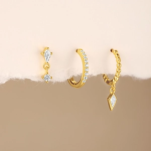 Macro shot of gold S925 silver earring set featuring sparkling marquise cubic zirconia