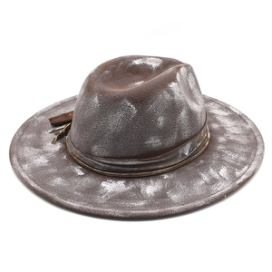 Close-up of distressed wool felt fedora featuring vintage leather band and western details