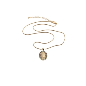 Detailed close-up of a golden oval Virgin Mary pendant with colorful gemstones and snake chain