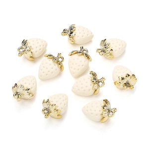 Detailed view of ten cream-colored strawberry pendants with golden hooks for DIY jewelry