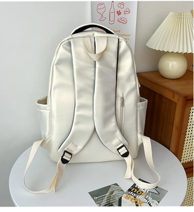 Detail view of cream white PU leather backpack back straps and side water bottle pocket