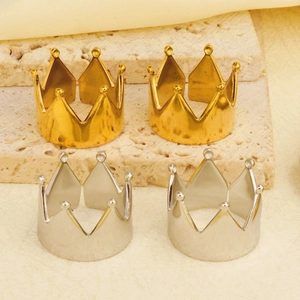 Detailed shot of gold and silver crown rings on a textured stone display pedestal