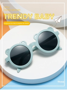 Detail of light blue bear-eared kids sunglasses on a geometric display stand