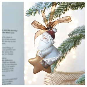 Close-up of Santa Claus on golden star ornament hanging from a snowy Christmas tree branch