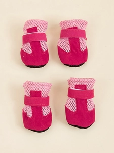 Detail view of four breathable rose red mesh dog shoes with anti-slip soles and Velcro straps