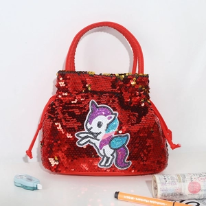 Detail of red sequin handbag featuring a unicorn patch and soft handles for girls