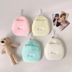 Flat lay detail of four colorful plush card holders with heart-shaped cutouts and clips