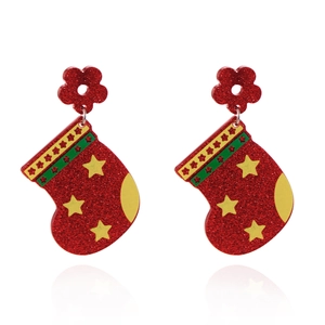 Macro view of Christmas stocking earrings with red glitter and yellow star patterns