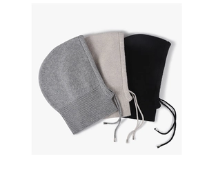 Detail of knitted balaclava beanies in grey, beige, and black with drawstring cords