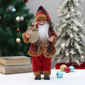 Standing Santa Claus doll holding twigs and gift bag by decorated Christmas trees