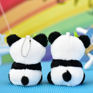 Back view of cute panda plush keychain with soft white fur and small green leaf detail