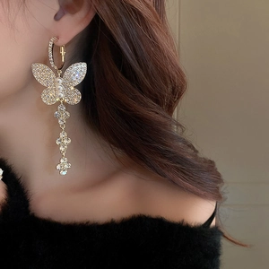 Elegant gold butterfly tassel earrings with sparkling rhinestones and white pearls