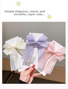 Set of three children's bow hair clips in cream, lilac, and pink with beaded edges