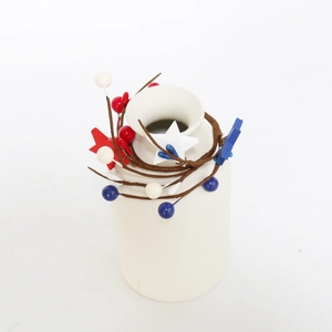 Minimalist white ceramic vase decorated with patriotic red white and blue star berries