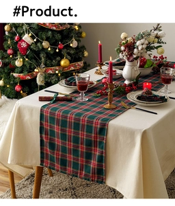Close-up of red and green plaid Christmas table runner with festive holiday dinner decor