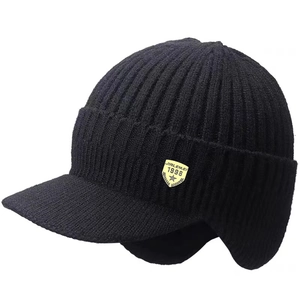 Detailed texture of black knit winter hat with fleece lining and shield logo patch