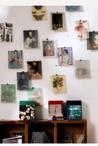 Artistic wall decor showing vintage aesthetic cards with plants and Van Gogh paintings