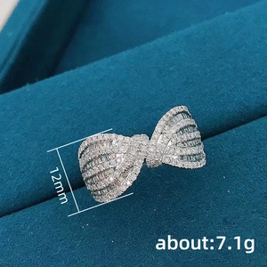 Minimalist bow-shaped ring with micro-pave zircons in premium polished silver finish