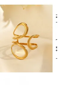 Macro shot of 18K gold plated hollow spiral geometric ring on beige silk fabric