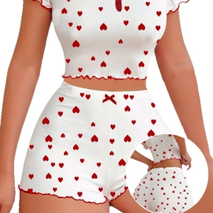 Women's two-piece heart print rib knit pajama set with ruffle trim and red bow detail