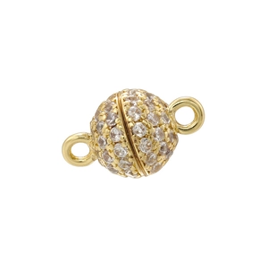 Macro view of gold-plated spherical magnetic clasp with white cubic zirconia for DIY jewelry