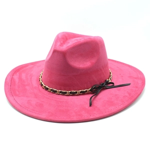 Detail of fuchsia suede fedora featuring golden chain and black cord decorative band