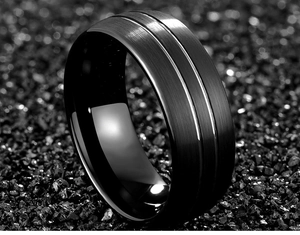 Macro detail of men's black brushed tungsten ring with a polished inner band on stone
