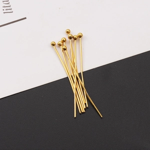 Close-up of golden stainless steel ball head pins for DIY jewelry making and beading