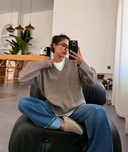 Mirror selfie showing the fit of the brown V-neck oversized knitted sweater top