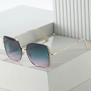 Detail of square oversized metal sunglasses with gradient lenses and rhinestone accents