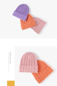 Detail of cable knit pattern and folded cuff on candy-colored winter beanies