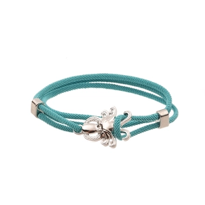 Close-up of teal nylon cord bracelet with a silver octopus charm and sparkling crystals