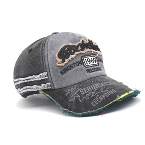 Close-up of vintage washed denim baseball cap with Rockstar embroidery and distressed holes