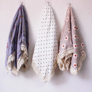 Detail of soft double-layer cotton baby blankets with tassels and floral star prints